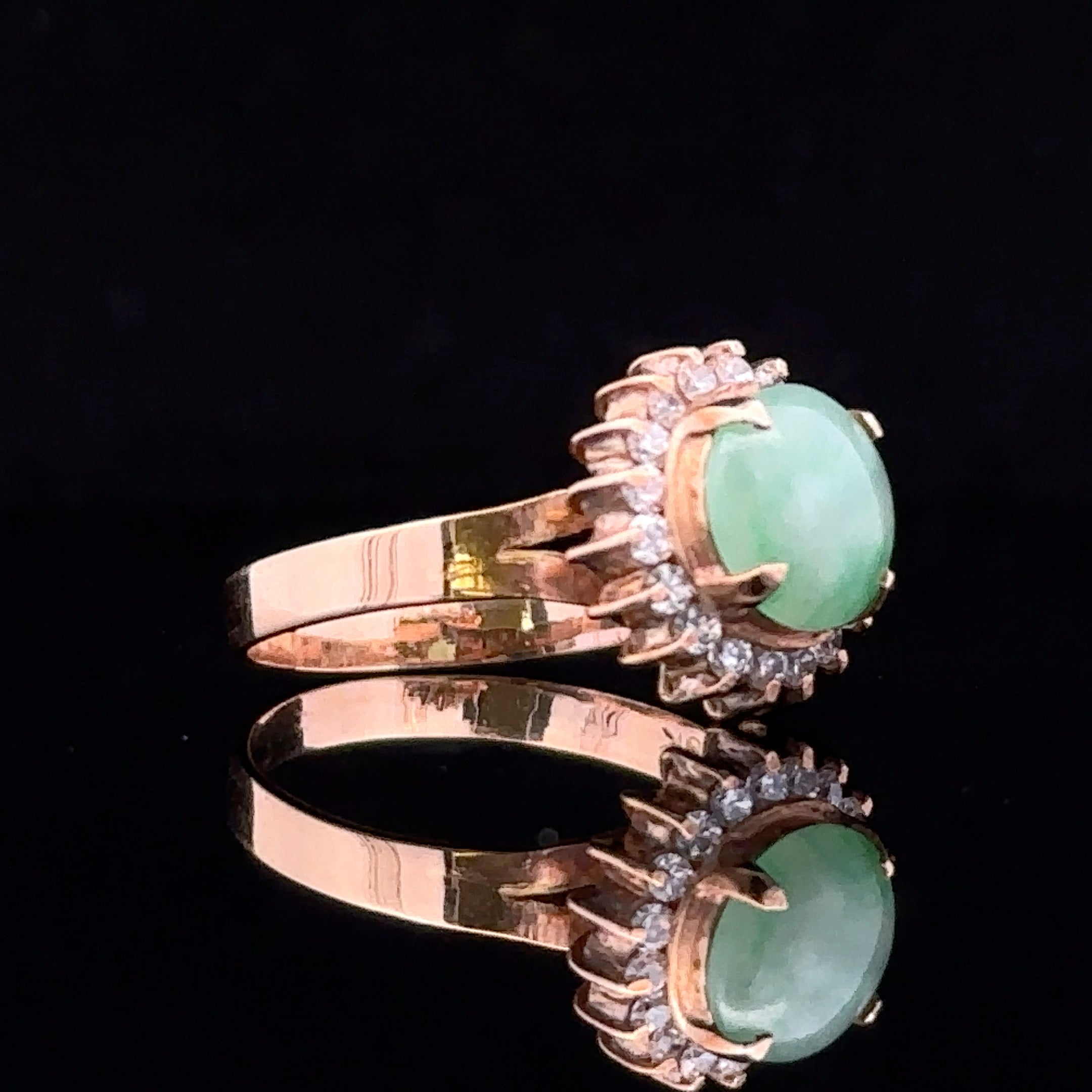 Close-up of cabochon jade surrounded by diamonds in gold setting