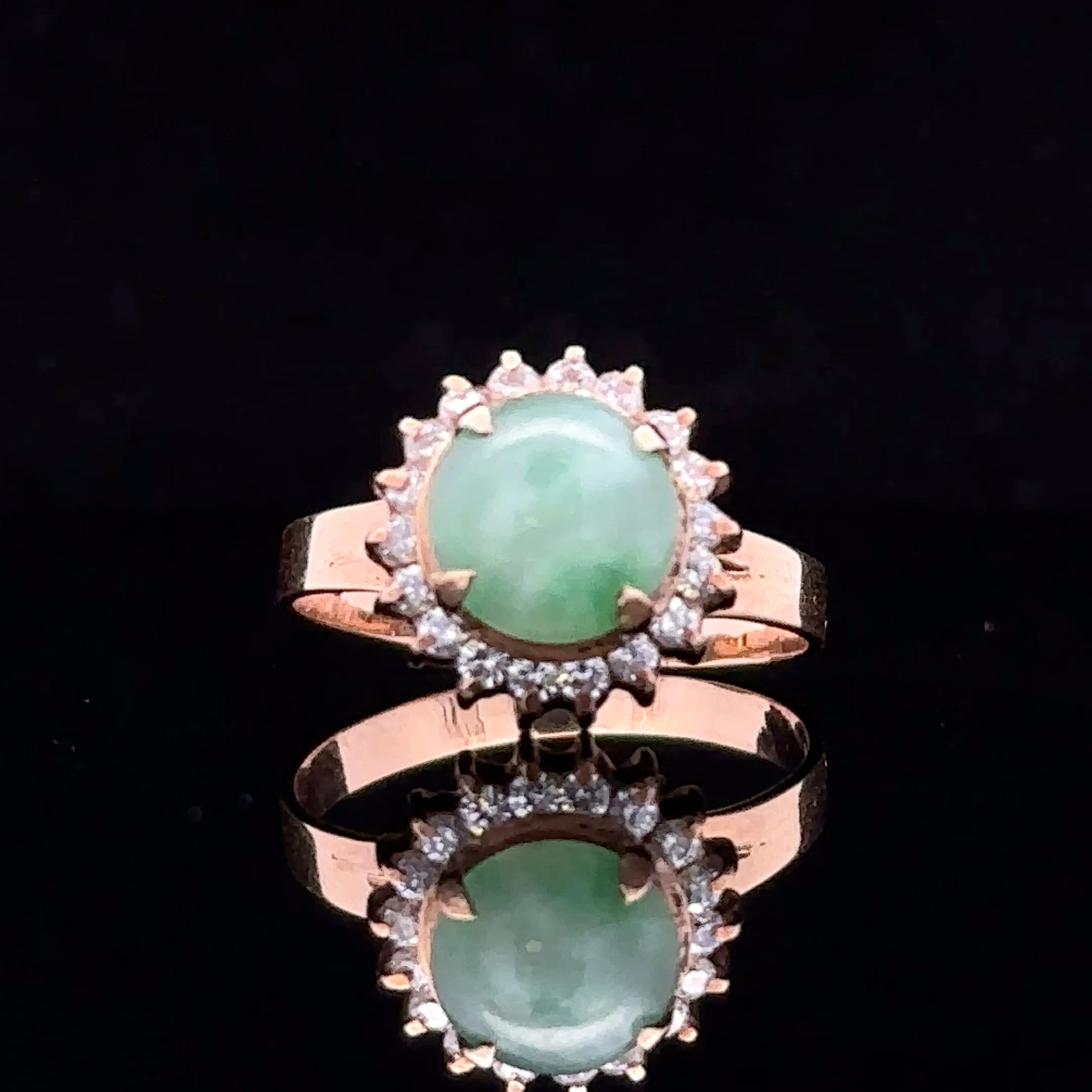 Yellow gold ring with cabochon jade and diamond halo