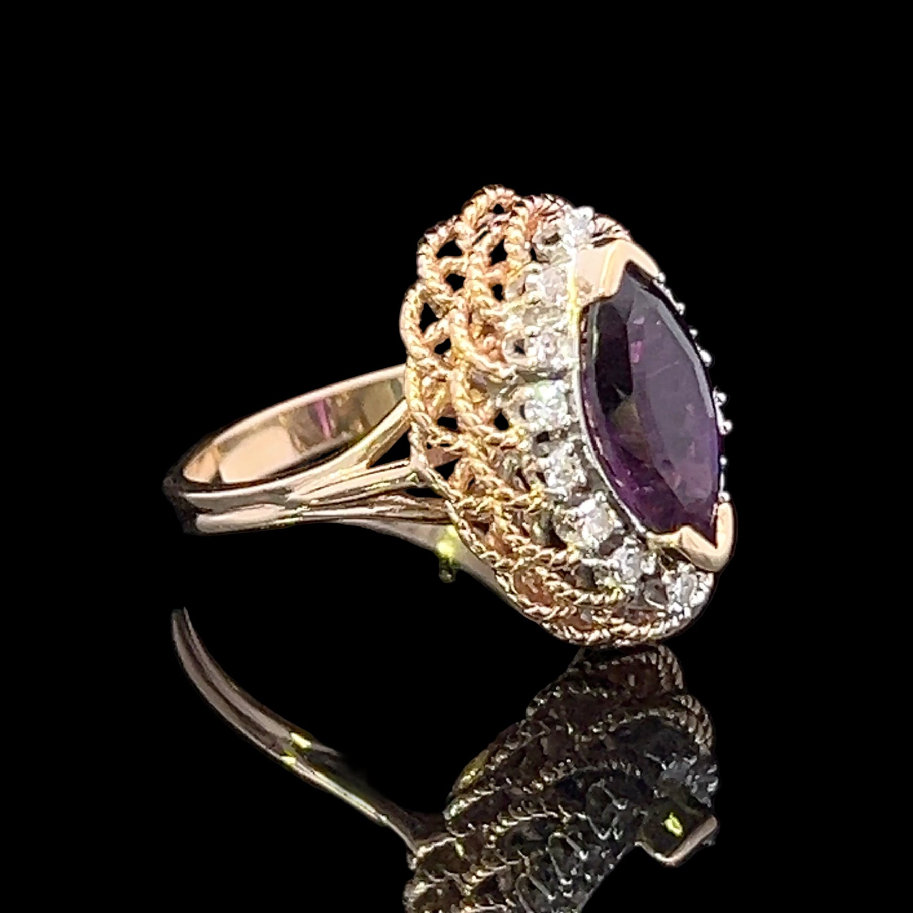 Gold ring with a purple gemstone on a black background