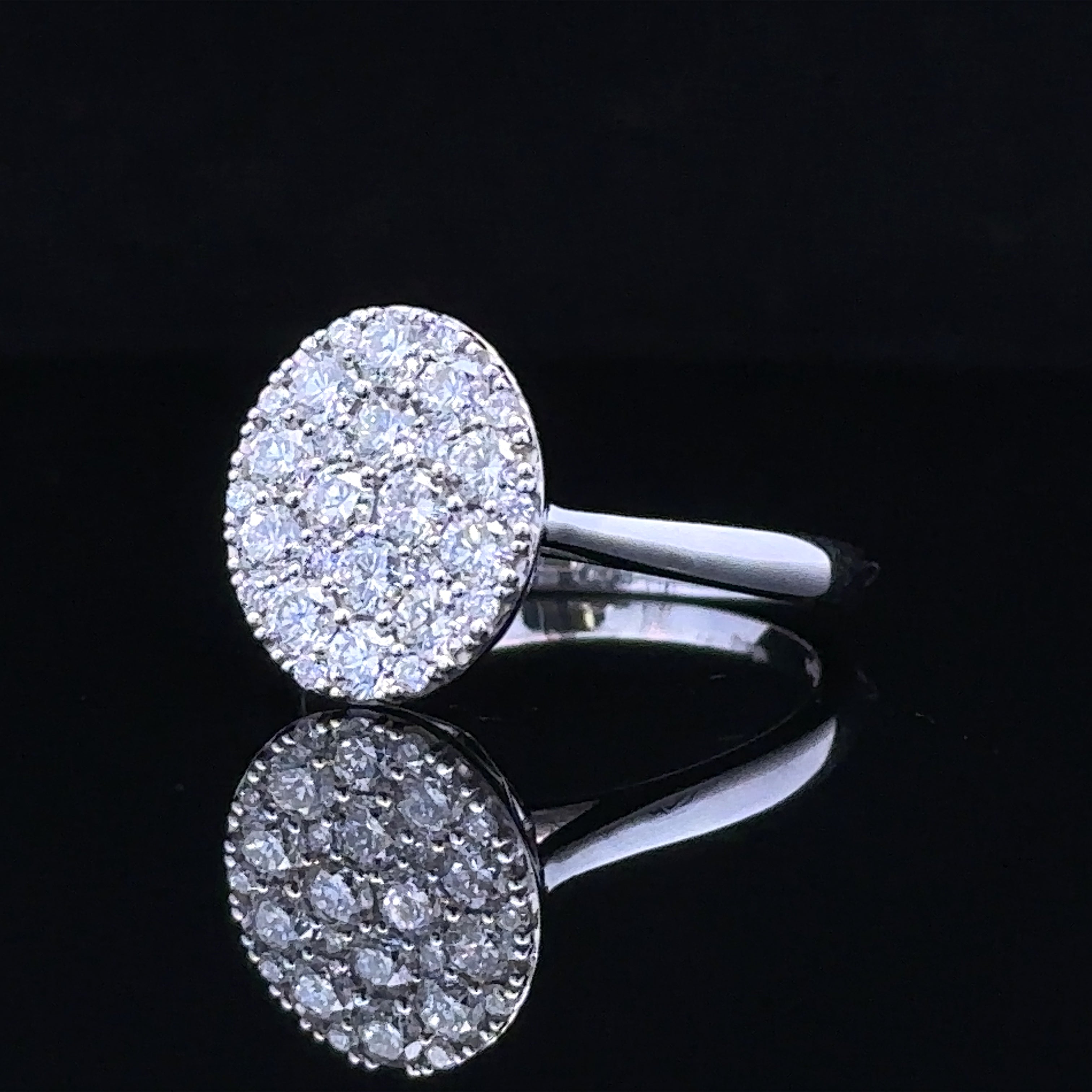 Oval cluster white gold ring with round diamonds