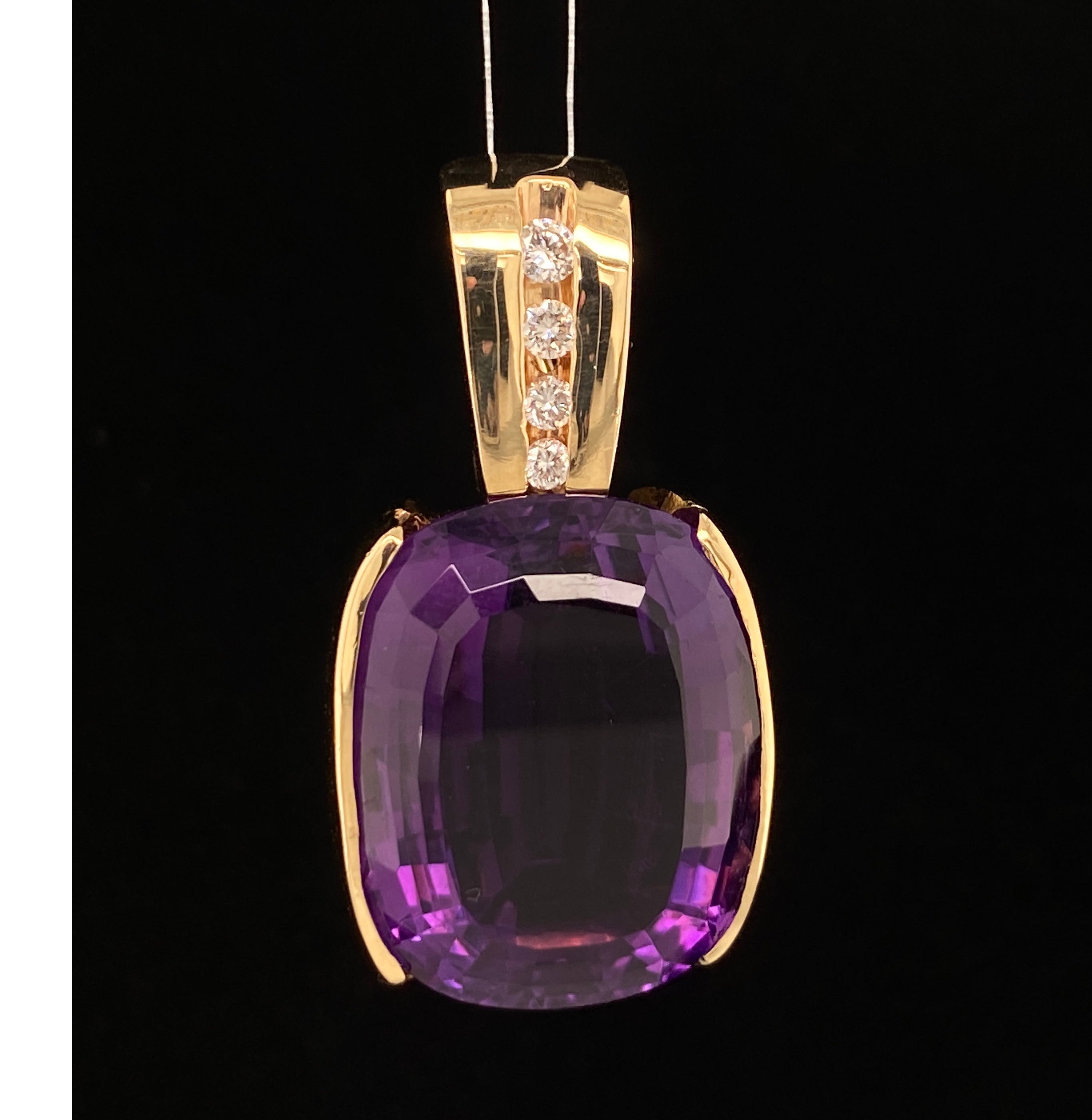 Yellow gold free form pendant with purple amethyst