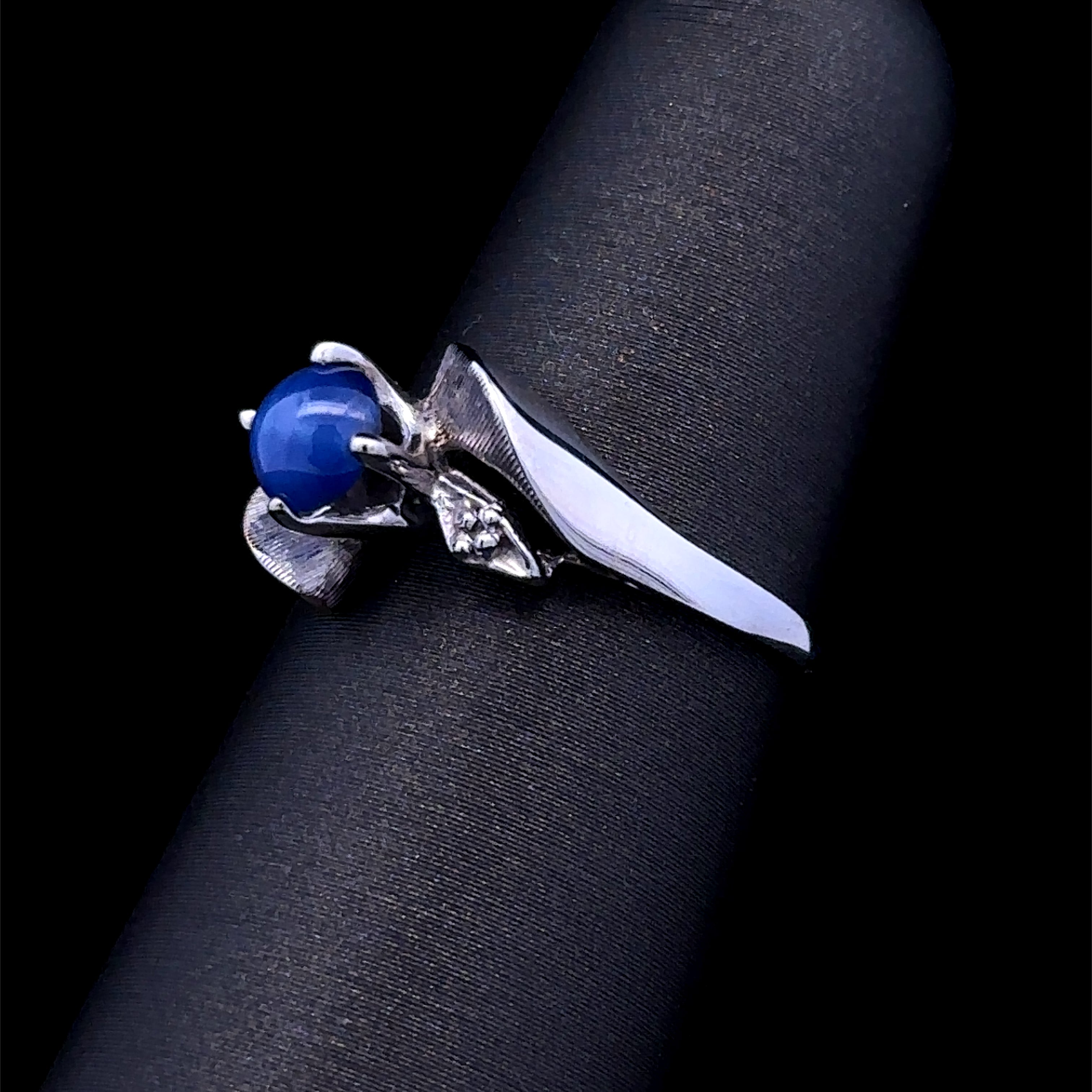 contemporary white gold ring with blue star stone
