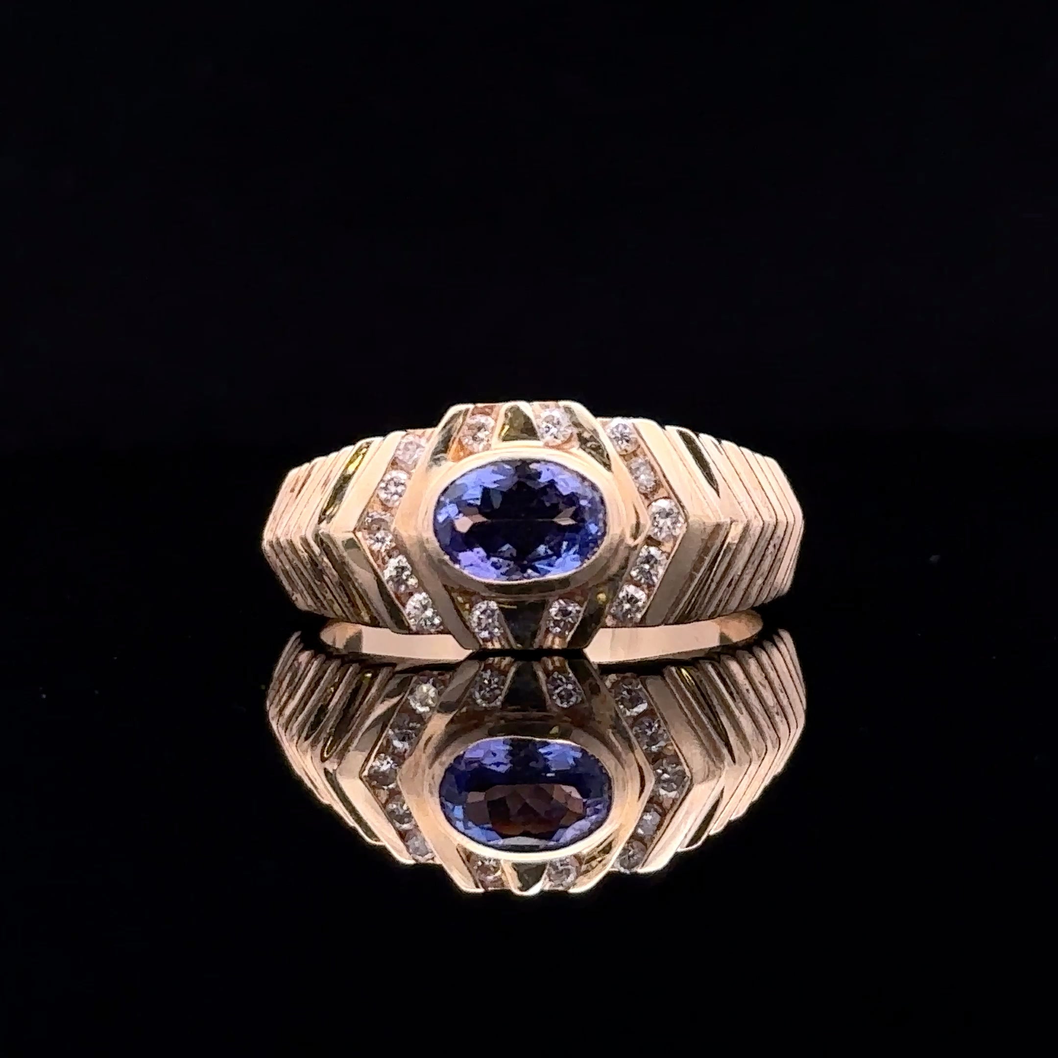 yellow gold ring with oval tanzanite and diamonds