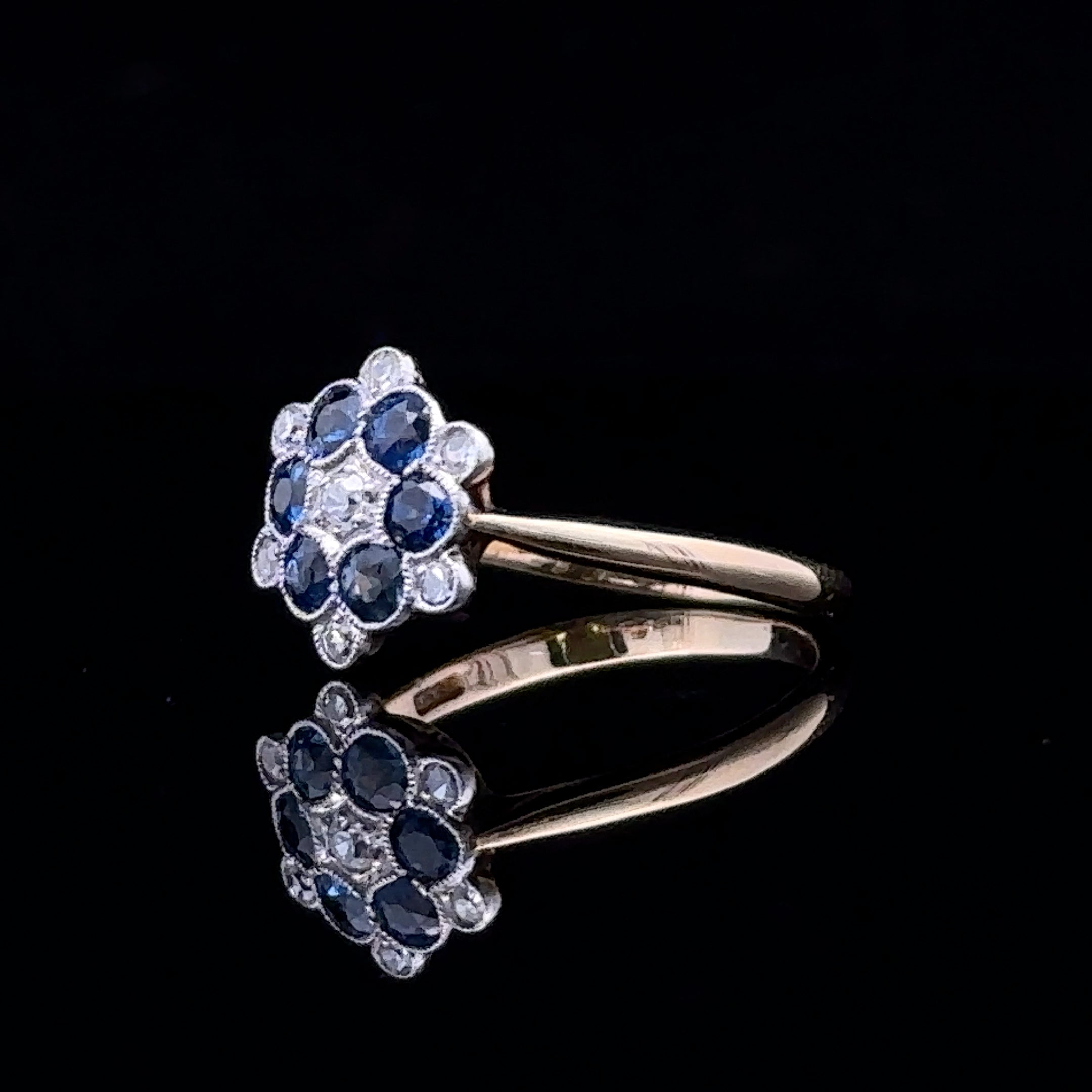 Yellow gold ring with sapphire and diamond accents
