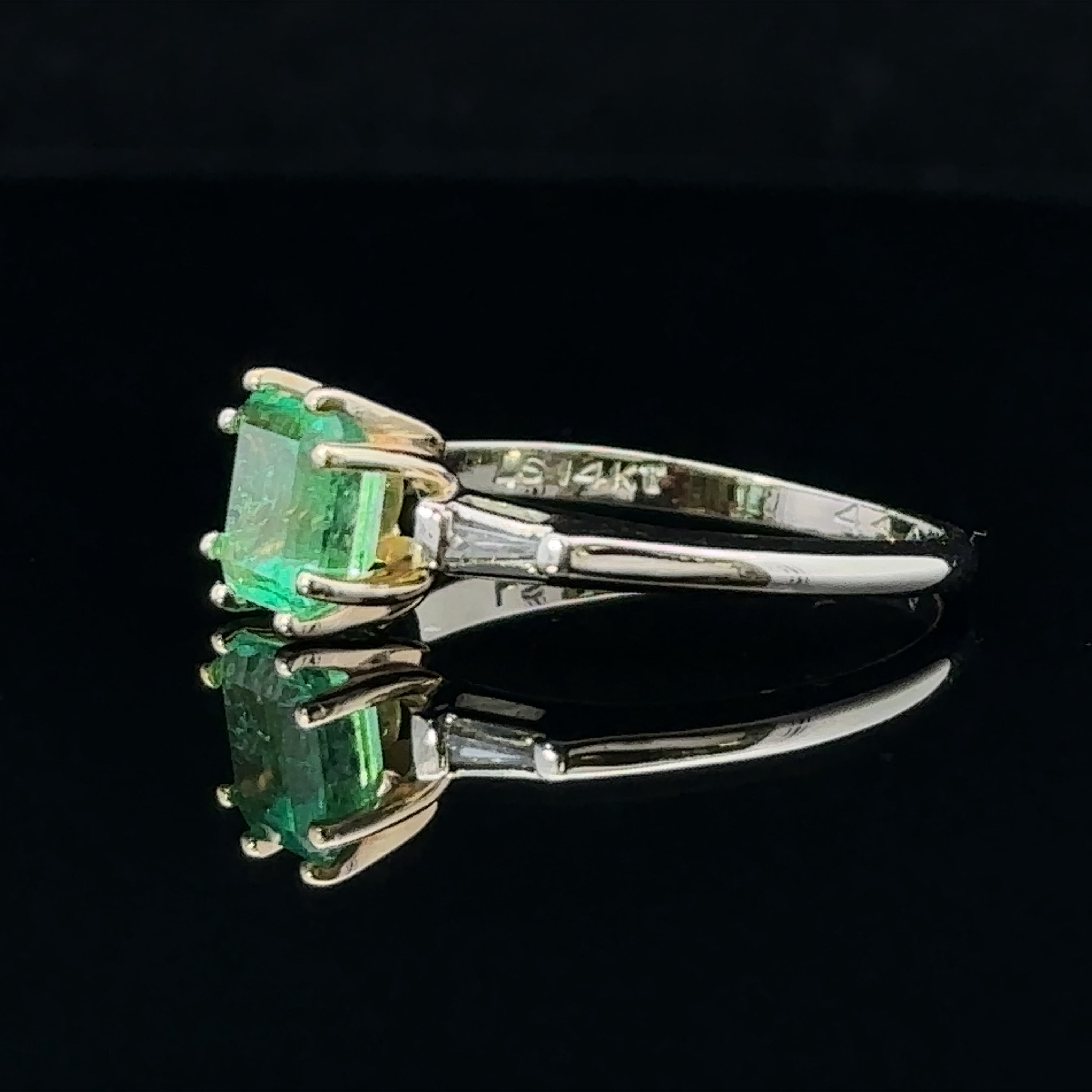 Square green emerald ring with baguette diamonds
