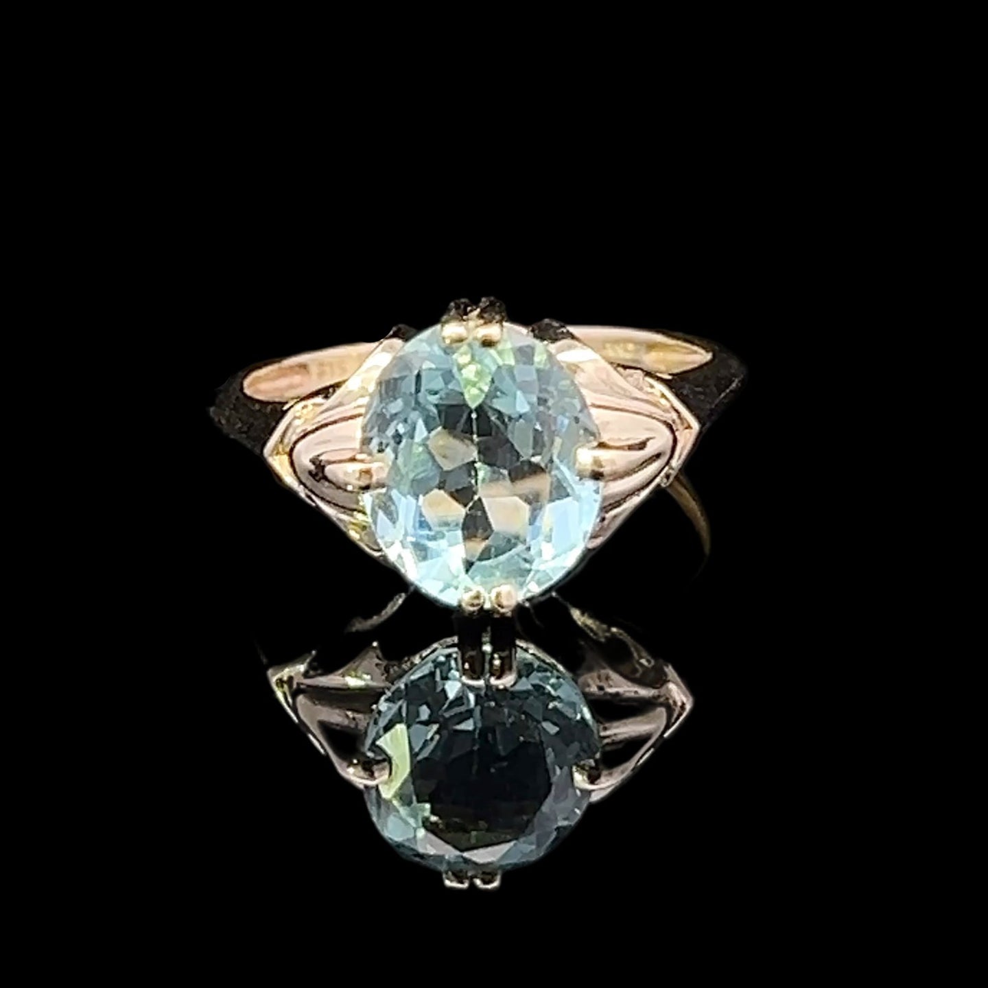 Ring with a green gemstone on a black background