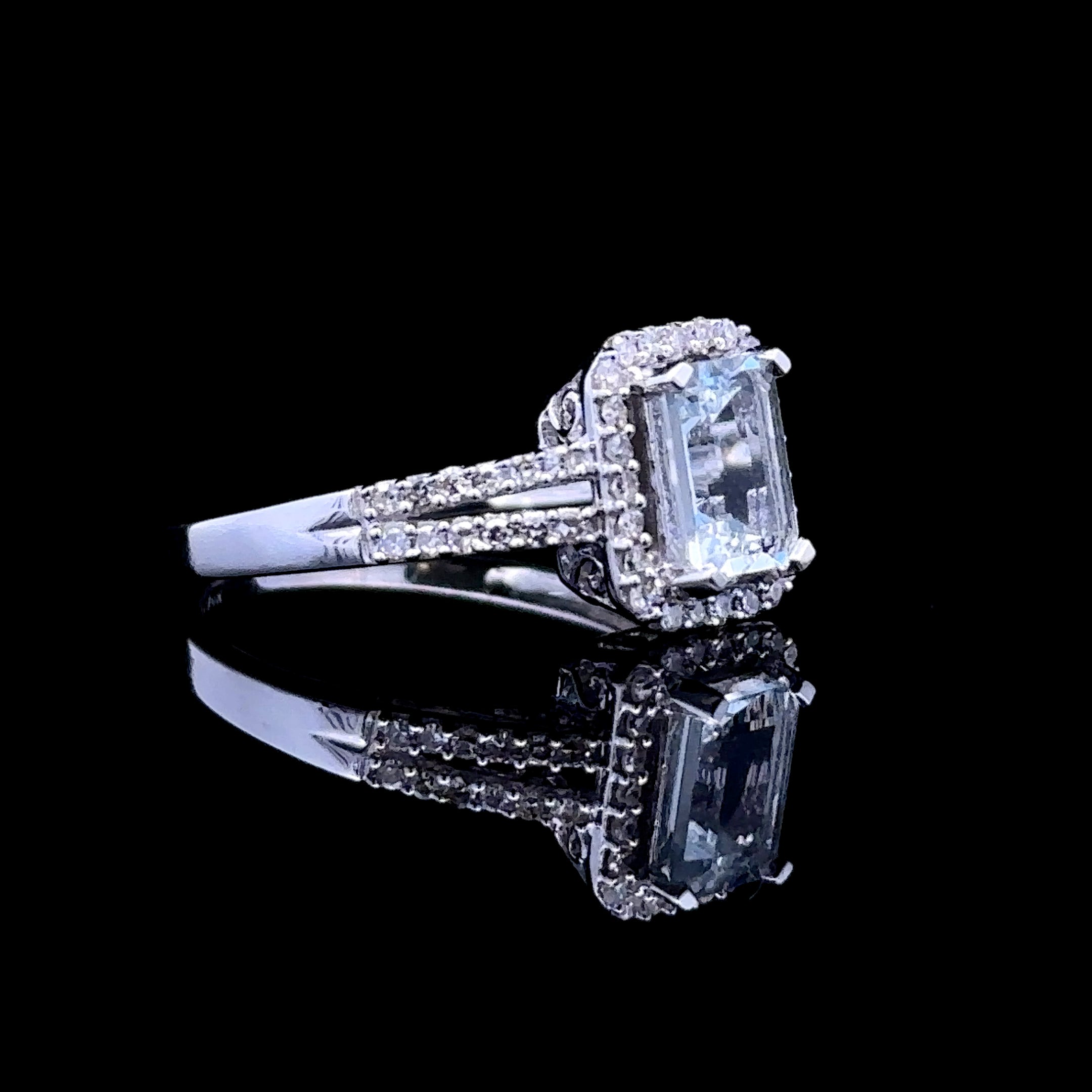 emerald-cut aquamarine ring with diamond halo
