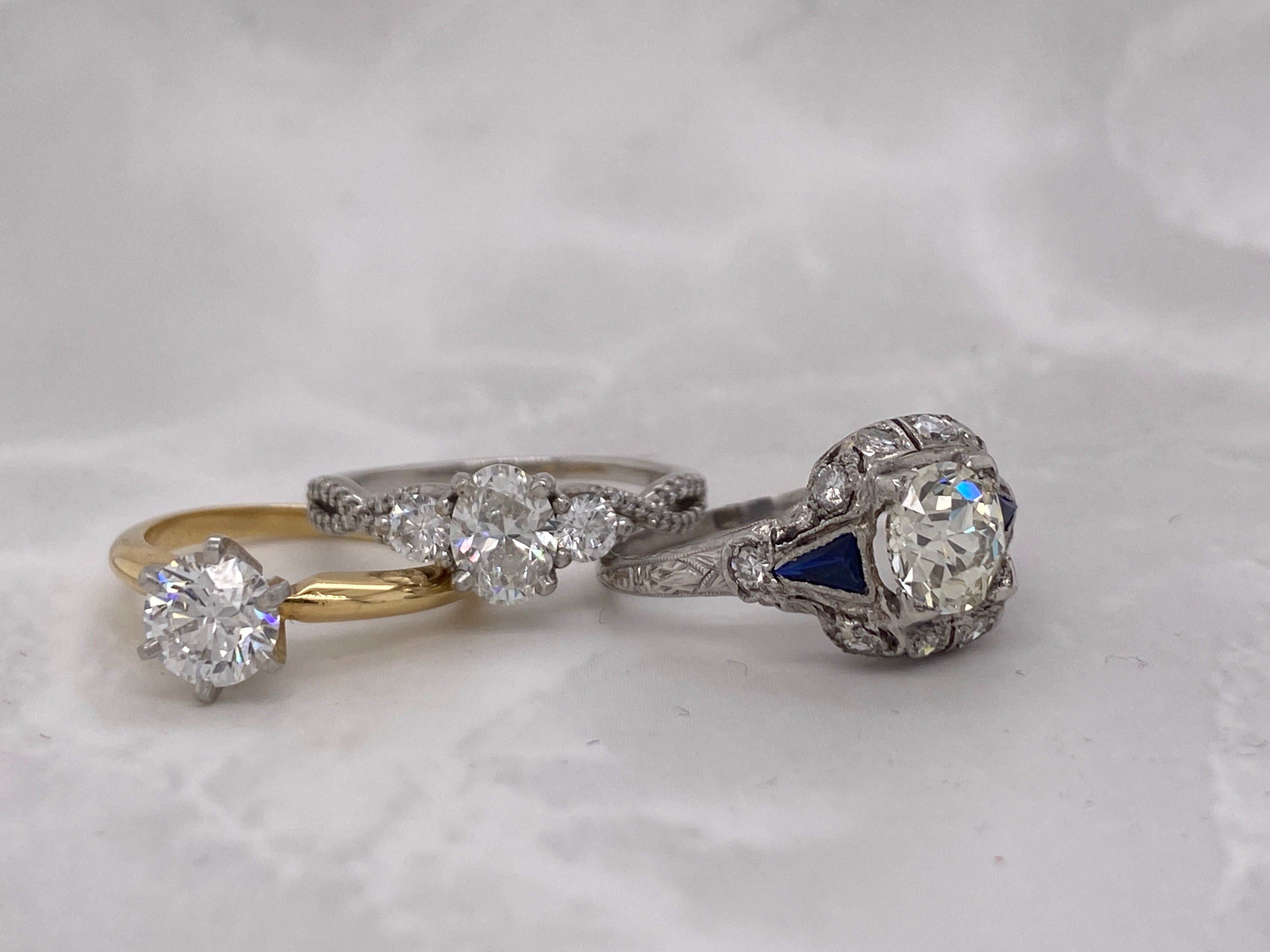 A variety of engagement rings, including solitaires, three stone, and vintage designs.