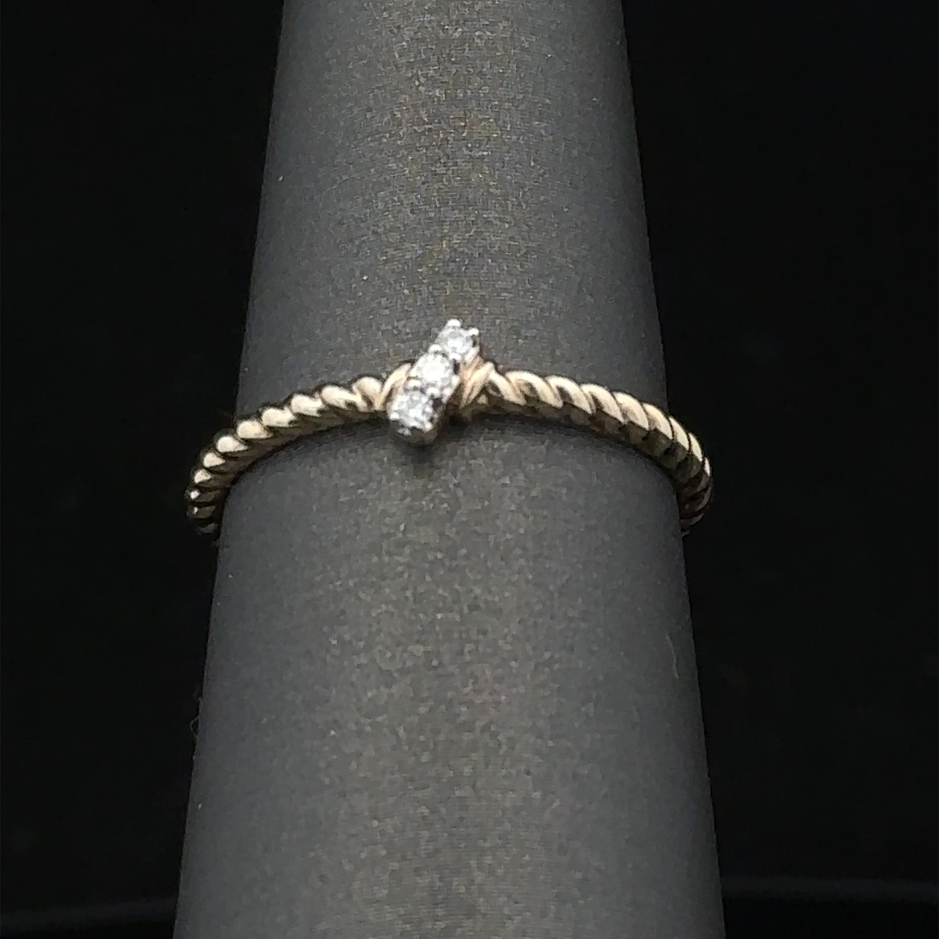 Yellow gold twist ring with diamonds