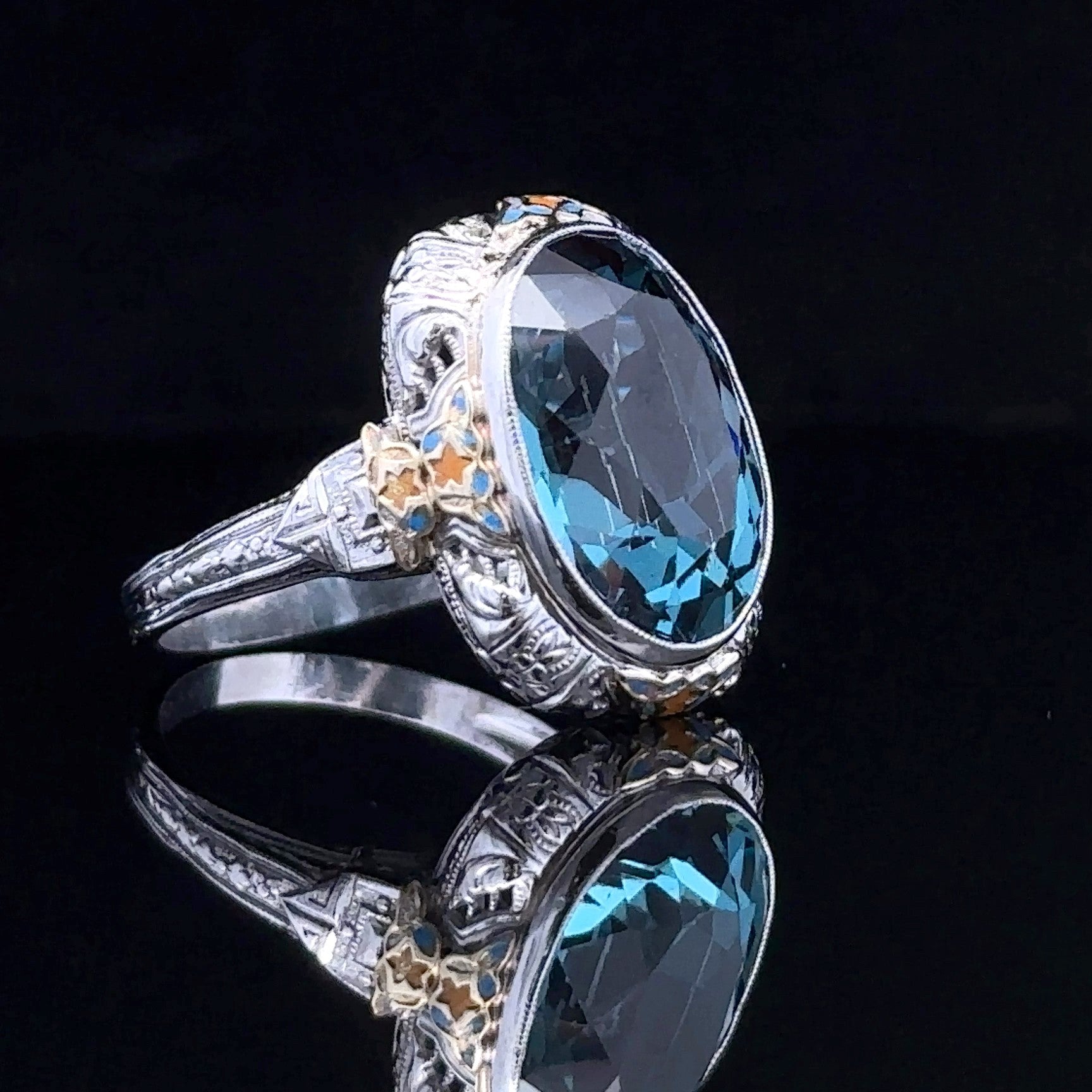 two-tone fashion ring with oval blue topaz
