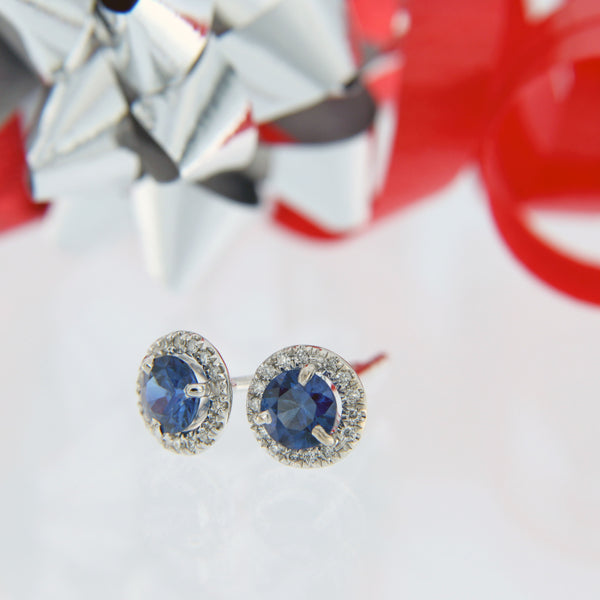 round blue sapphire with diamond halo post earrings 18 karat white gold